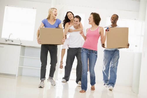 Professional movers handling boxes and furniture in East London
