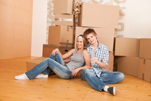 Professional movers handling boxes and furniture in a Hackney flat
