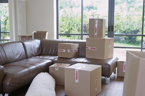Movers navigating a narrow Hackney staircase with care